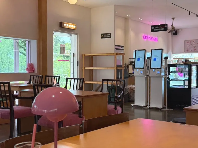 Table seating with outlets at Pink Wall Cafe