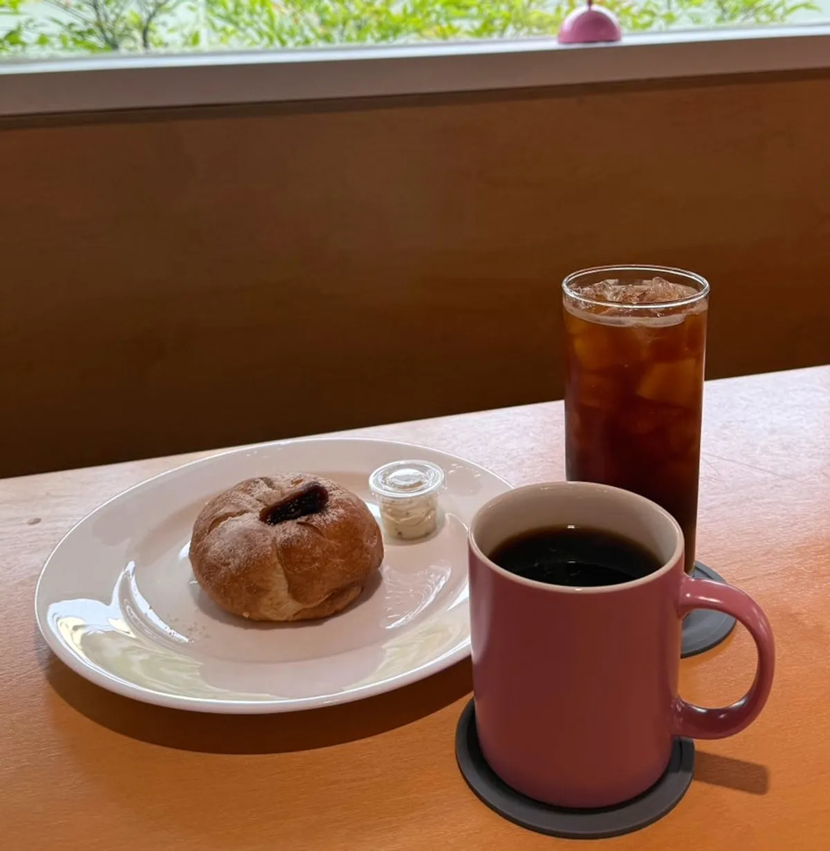 Fig bagel and two Americanos at Pink Wall Cafe