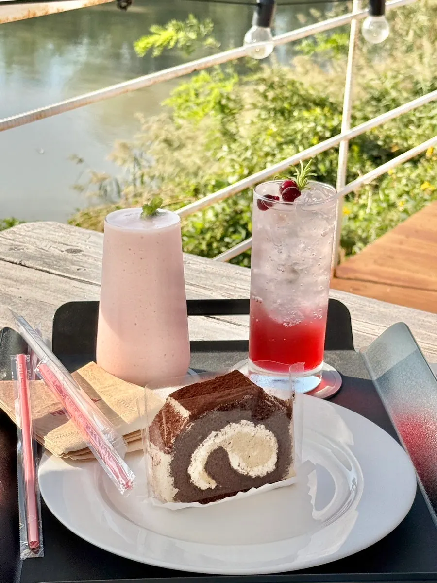 Bakery items and drinks on a table at Pink Wall Cafe