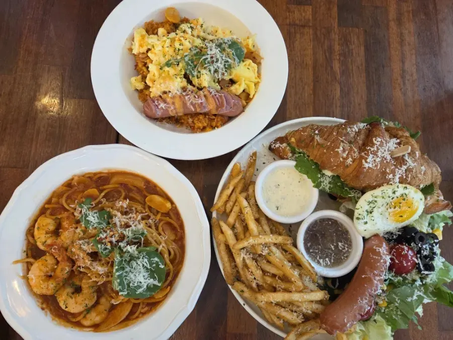 Full table shot of Pino Cafe's three brunch dishes