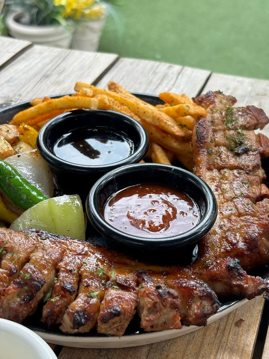Charcoal-grilled whole pork belly steak platter with two sauces
