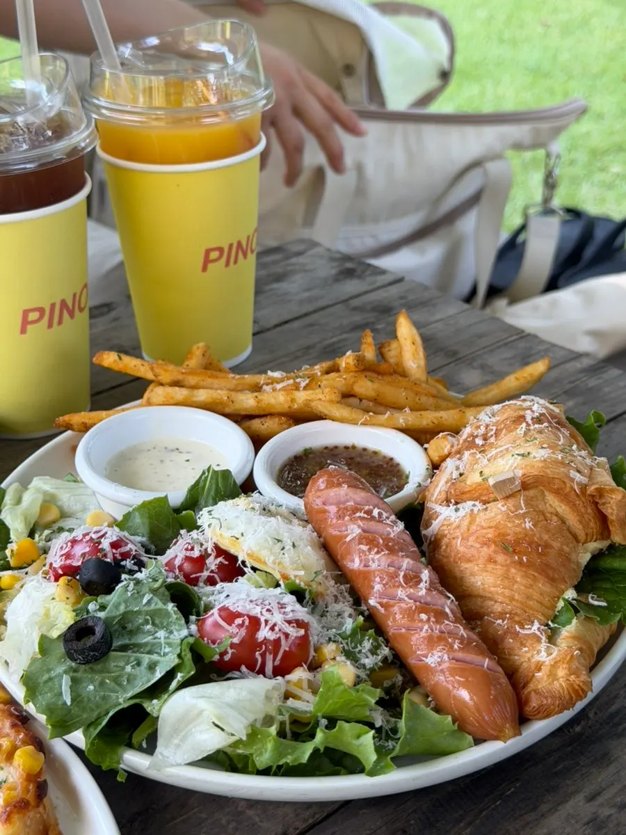 Croissant platter, corn cheese pizza, and drinks set out together