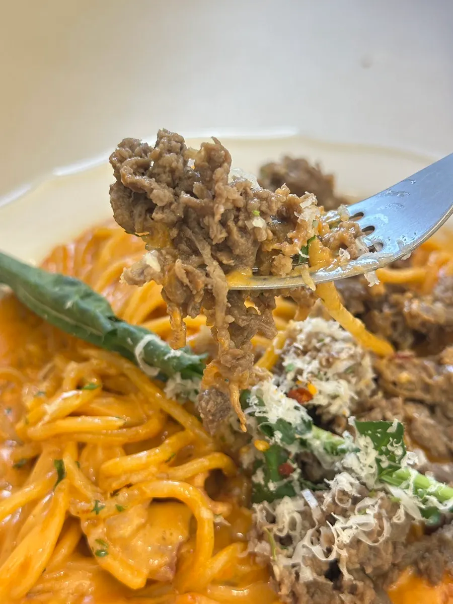 Rosé pasta noodles well soaked in sauce with bulgogi