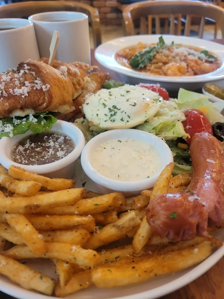 Soft-boiled egg salad served with sausage and fries