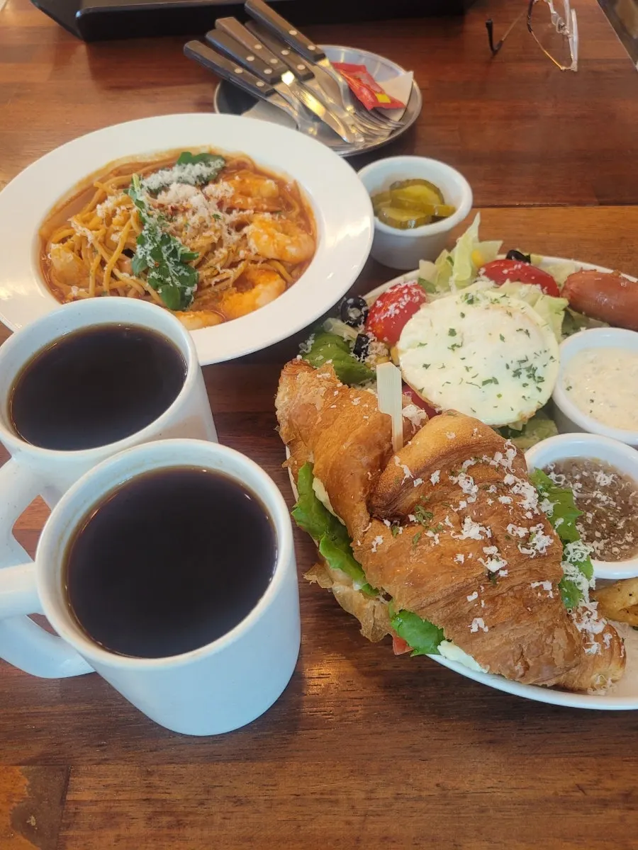 Sandwich set and pasta placed together on the table