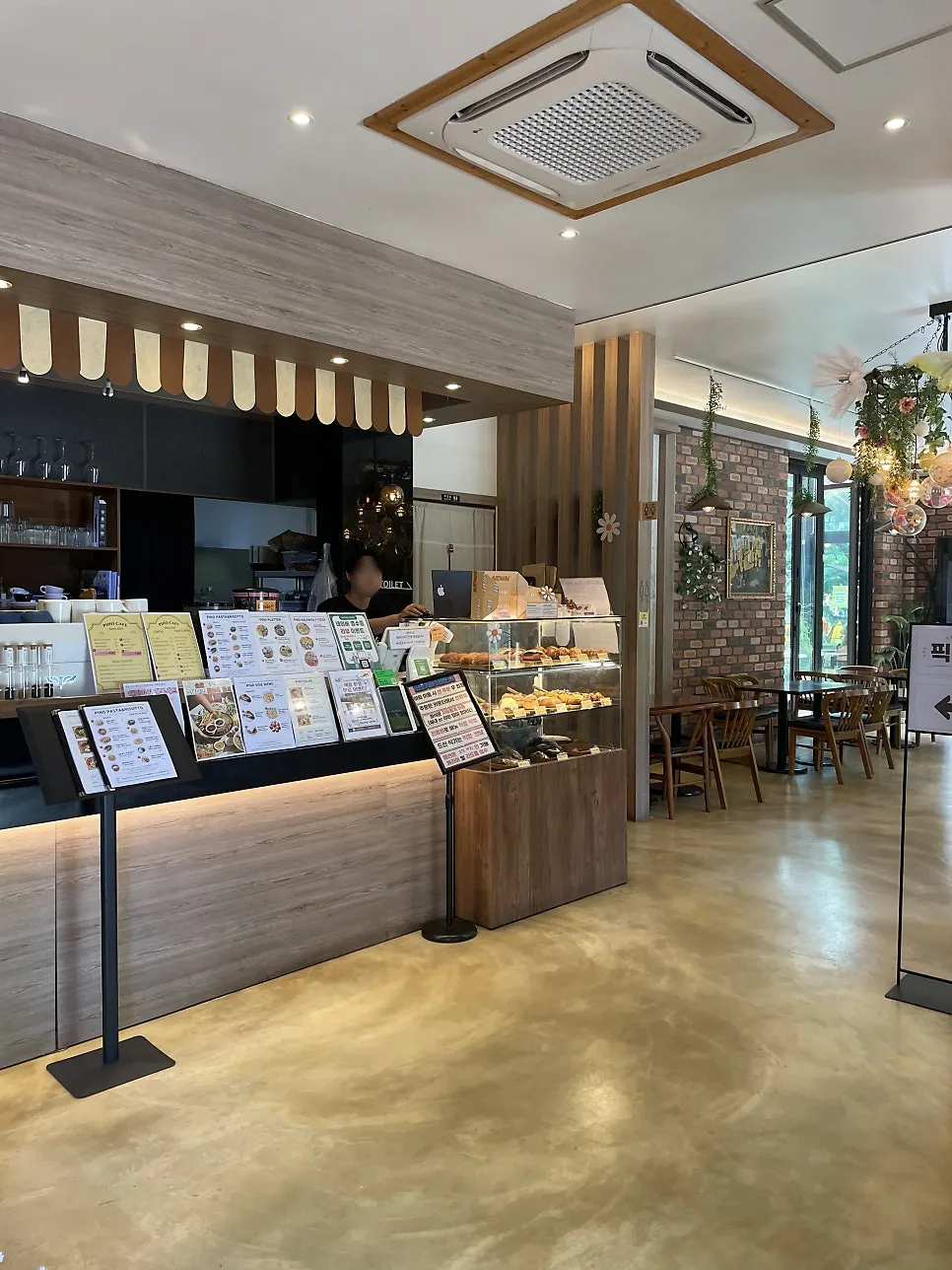 Interior of Pino Cafe with garden view through the windows