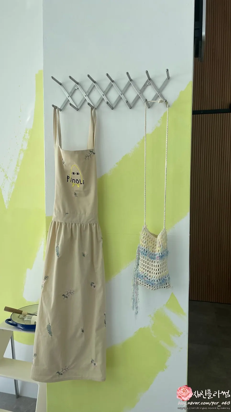 Aprons and bags hanging on the wall at Pinoli