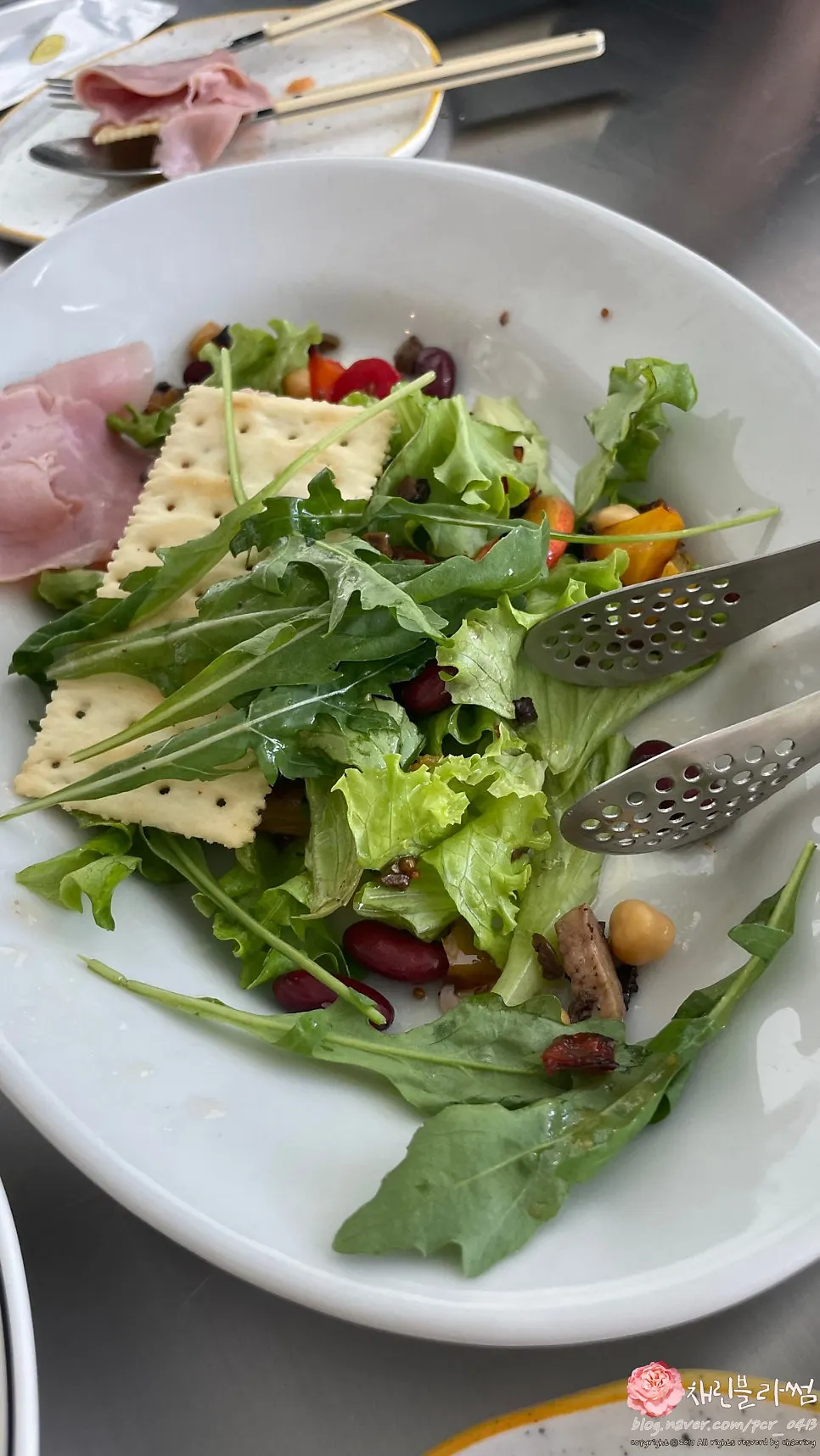 Jambon ham and salad piled on a cracker