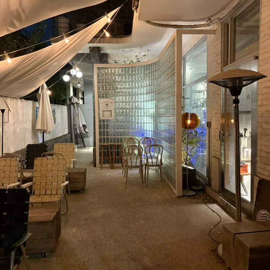 Café entrance with customers coming and going in the evening