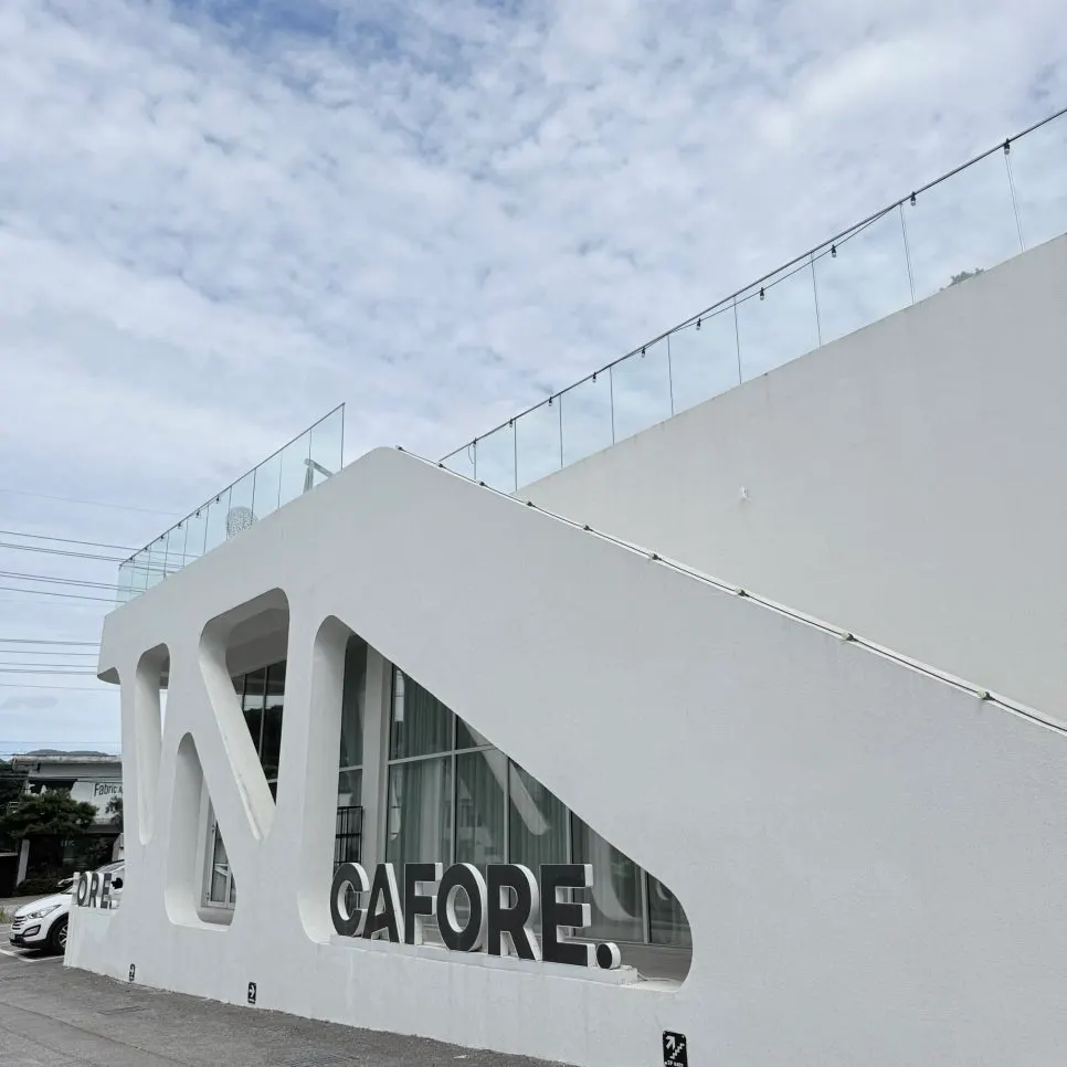 Exterior of the large white bakery café building