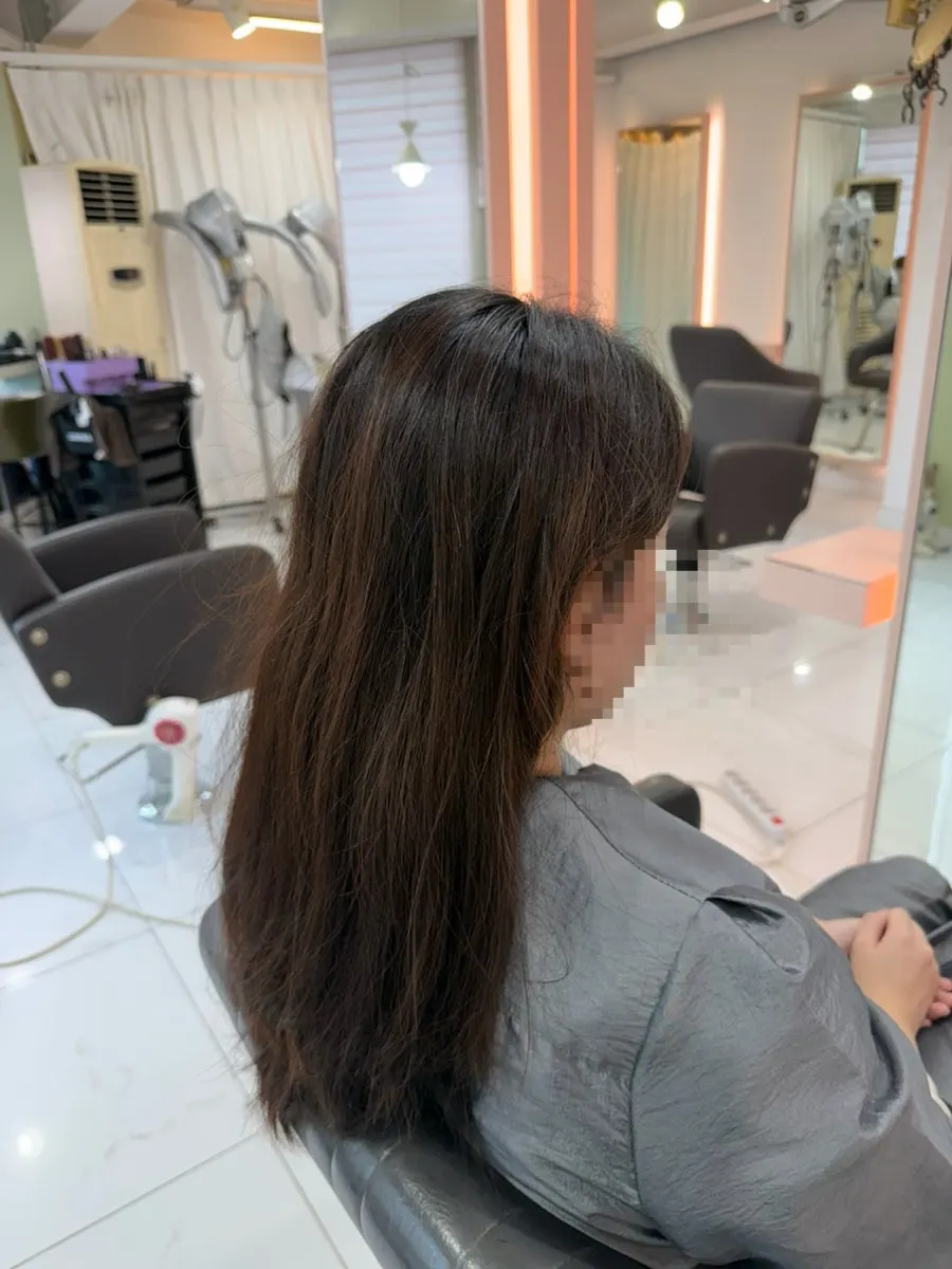 Before photo showing gray hair at the crown before root touch-up