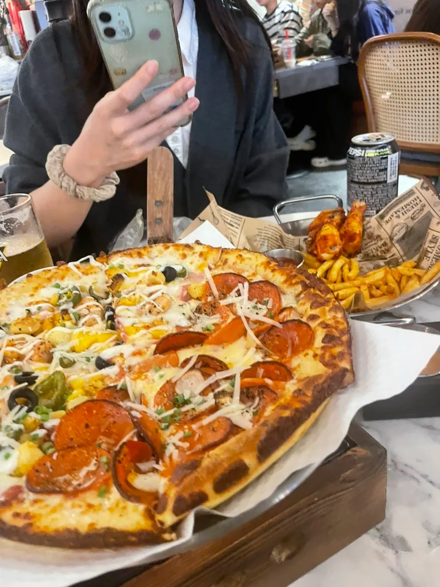 Close-up of half-and-half pizza with generous toppings