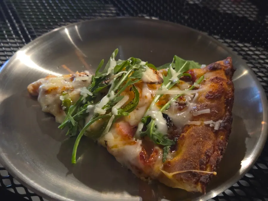 Garlic shrimp pizza piled high with rucola