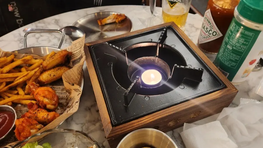 Flame lit at the table before the pizza arrives