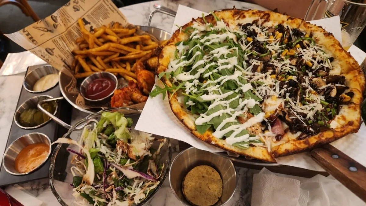 Full spread with half-and-half pizza and sides
