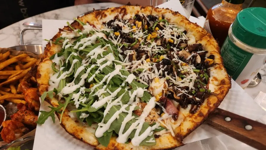 Half-and-half rucola garlic shrimp and Philly cheese barbecue steak pizza