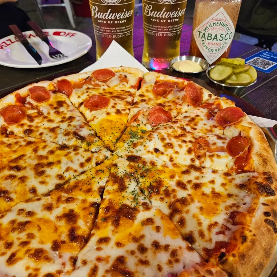 Budweiser draft beer enjoyed with the pizza