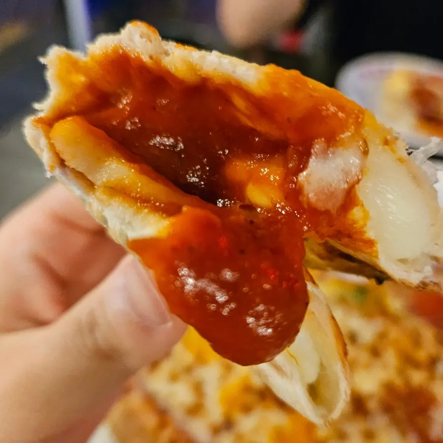 A slice of pizza with added cheese crust