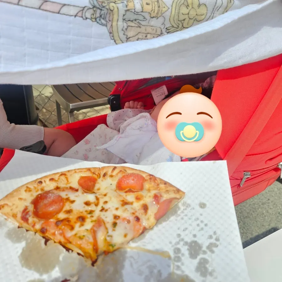 Enjoying the pizza at the outdoor table