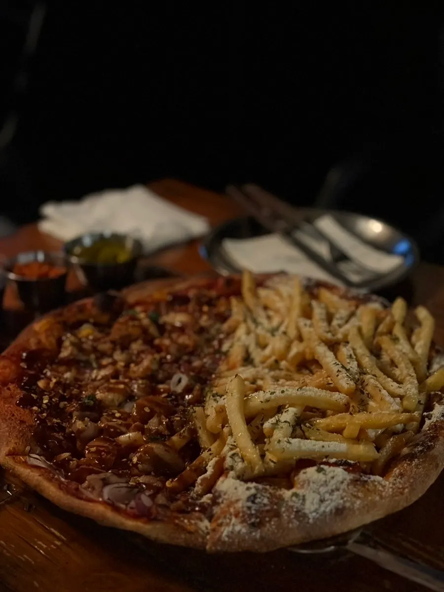 A whole half-and-half pizza of Chicken Never Sleeps and Potato