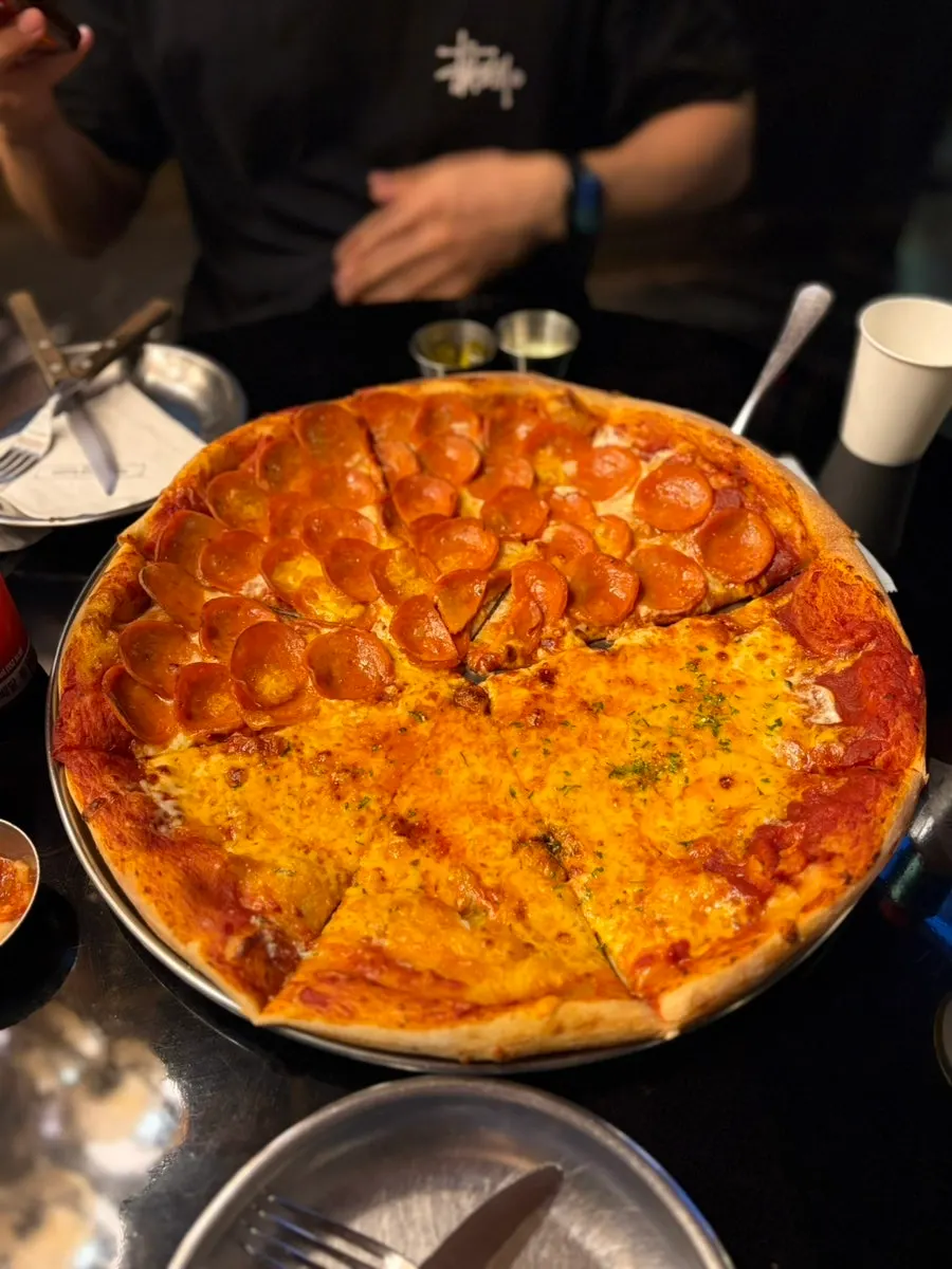 American-style pizza with thin crust and generous toppings