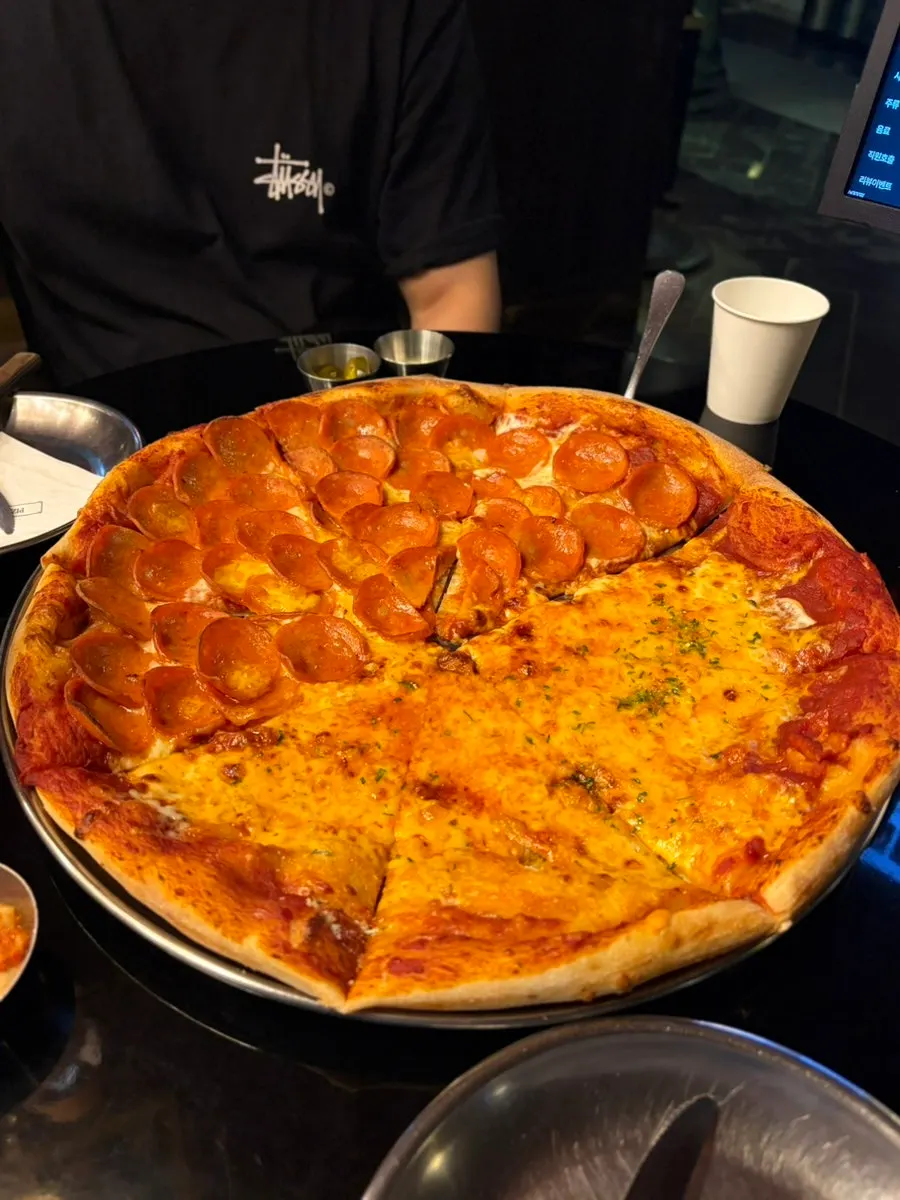 A slice of cheese pizza with stretchy melted cheese