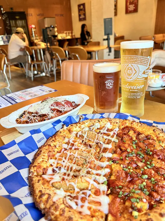Half-and-half pizza and pasta set on the table