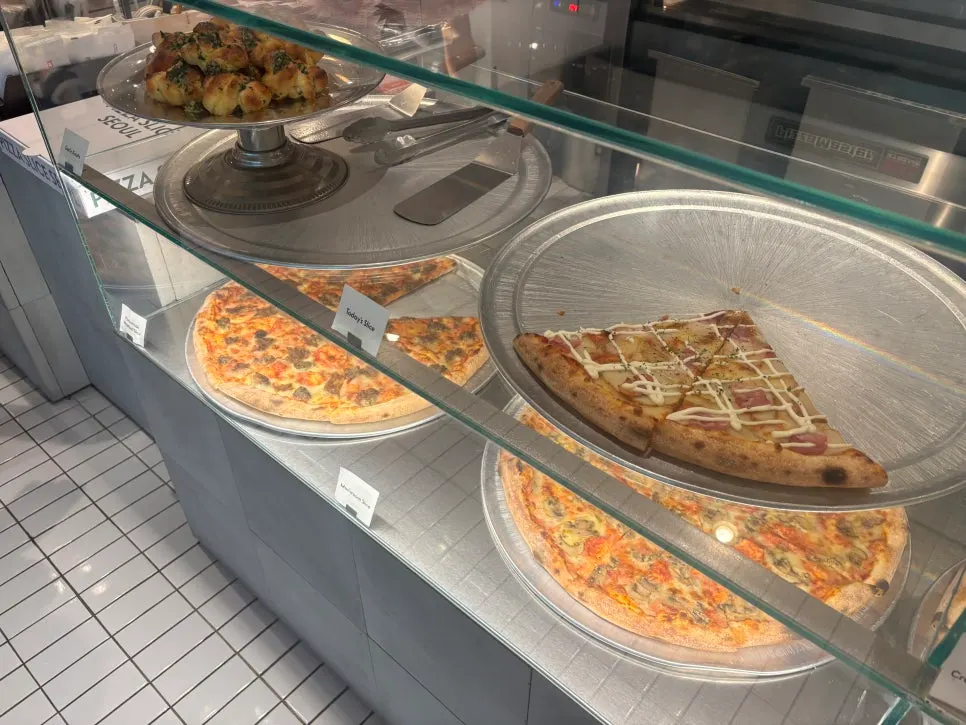 Open kitchen where dough is stretched and topped