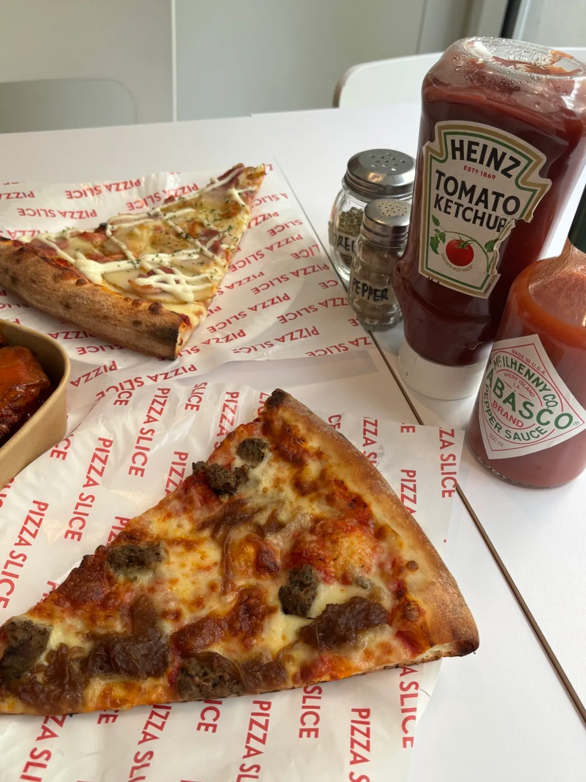 Oven-reheated pizza slice bigger than a palm