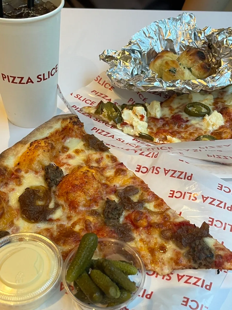 Pizza and garlic dipping sauce on the table