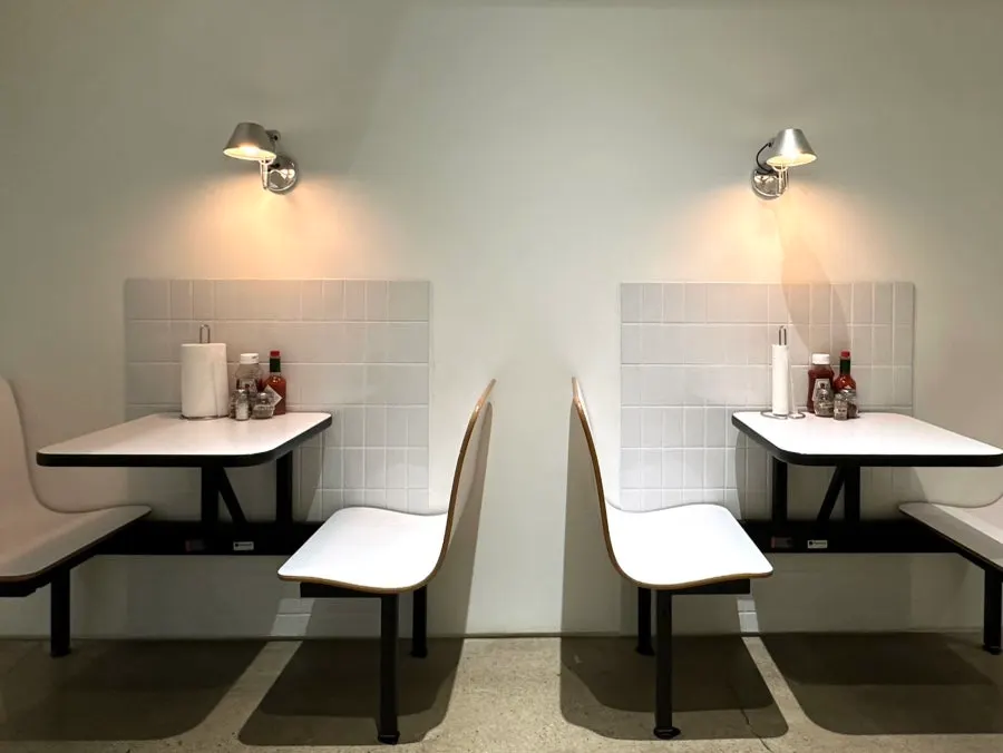 Well-spaced two-seat tables and large tables