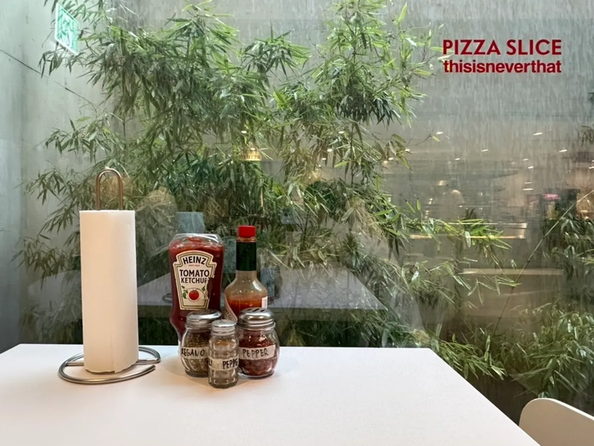 Bamboo outside the window and ketchup and sauce on the table