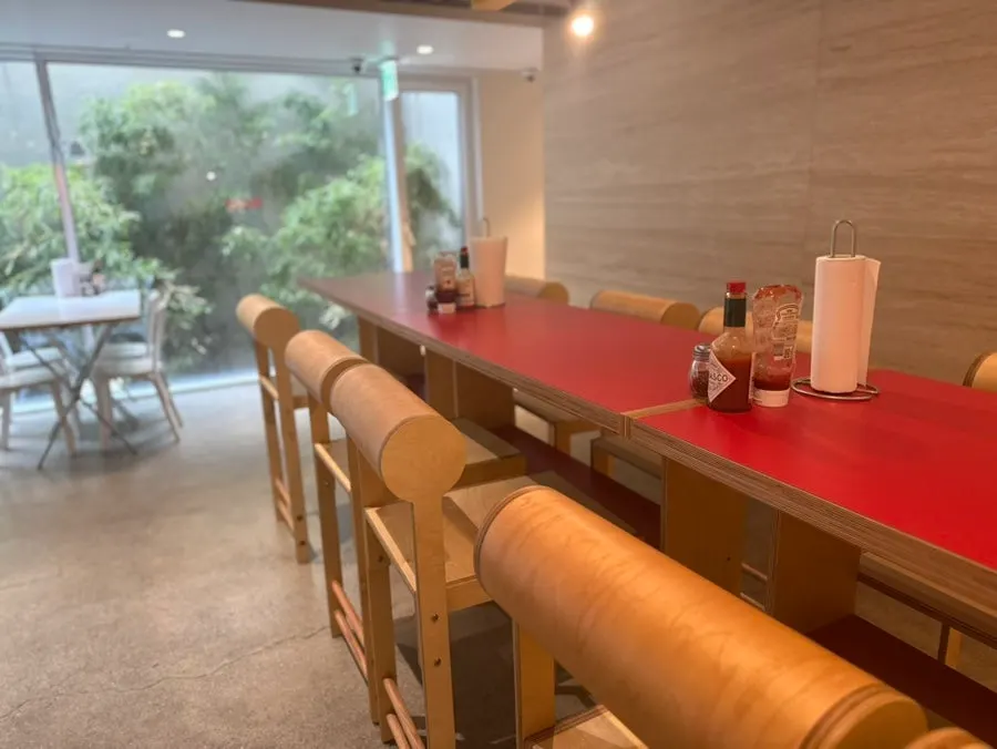 Single tables near the entrance and seating further inside