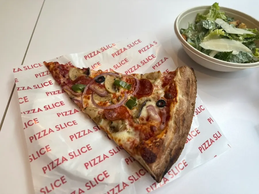 Menu board listing pizzas and side dishes