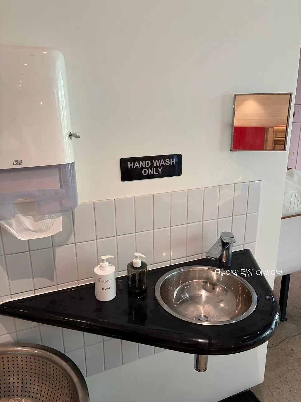 Small handwashing sink and hand soap by the bussing station