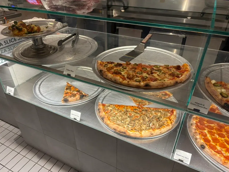 Menu board listing pizzas and side dishes