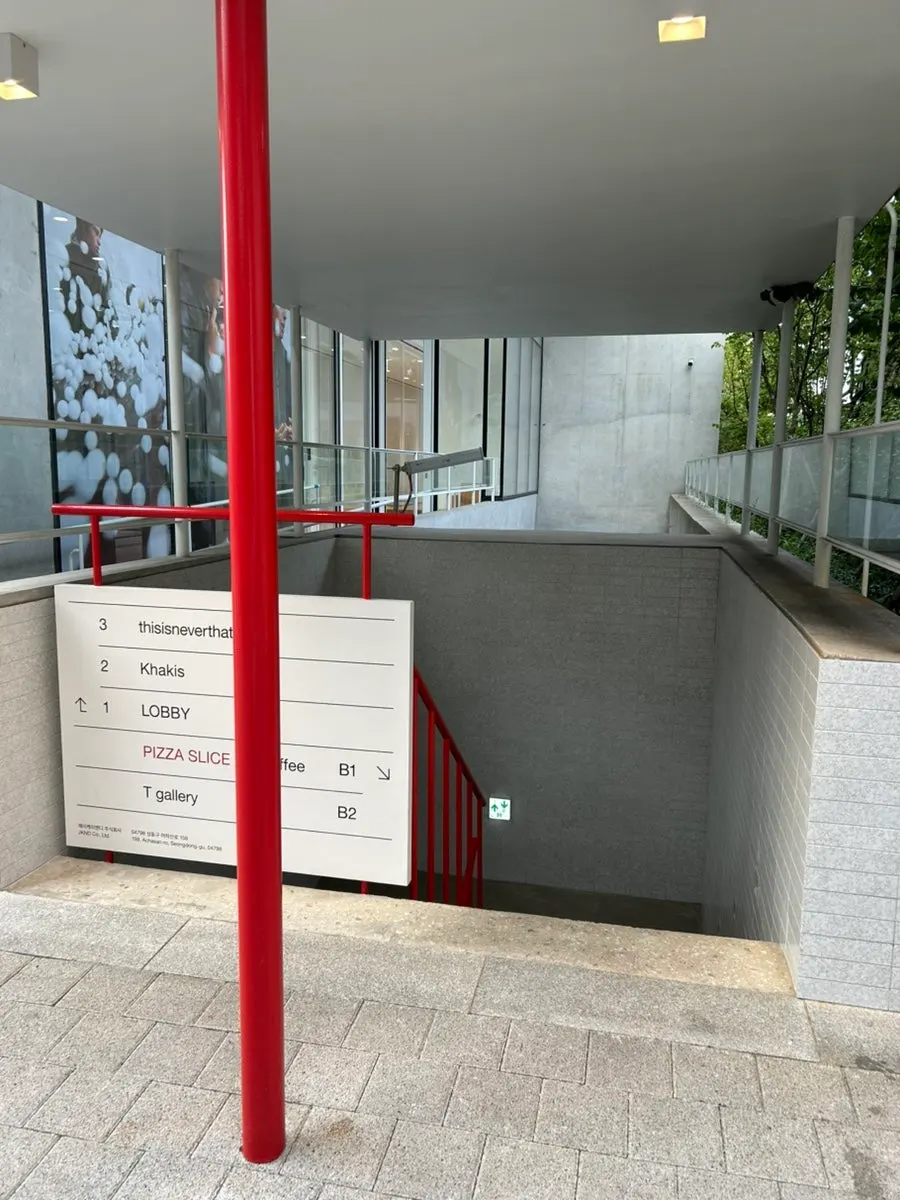 Stairs down to the basement entrance from the alley side