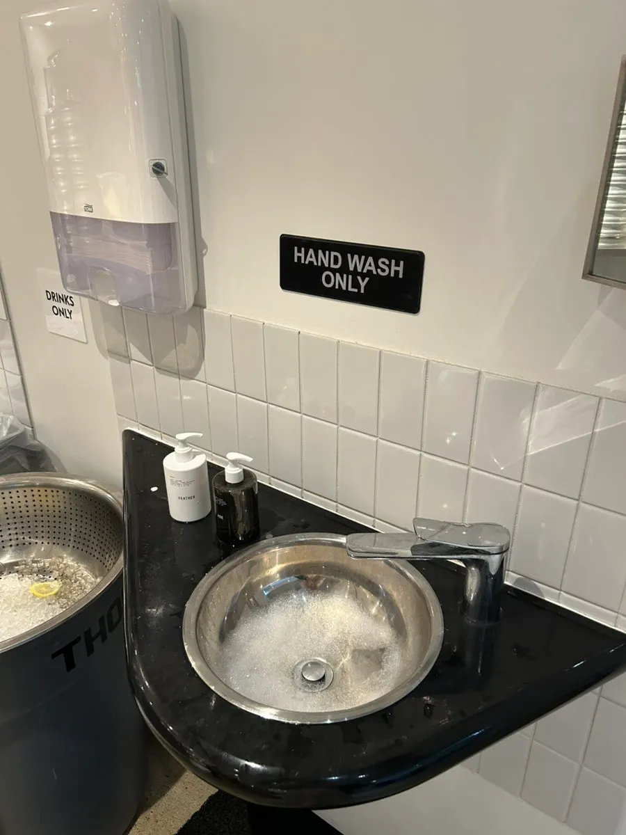 A hand-washing sink and towels off to one side of the store