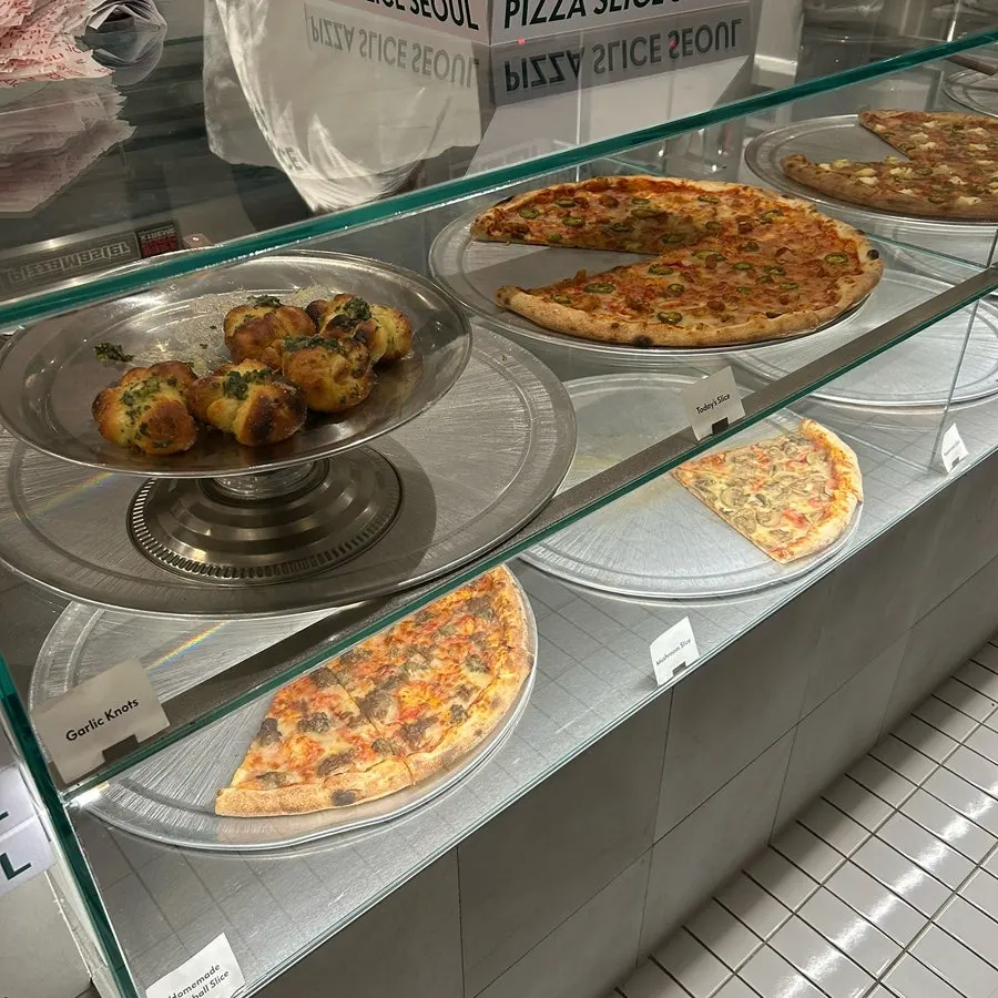 Slice pizzas displayed in the counter case