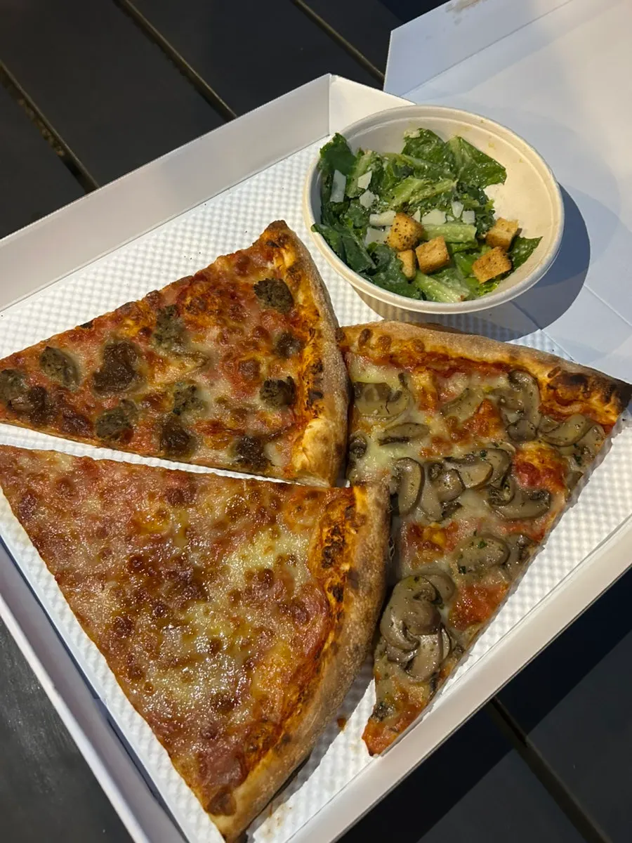 Big slices of pizza inside the opened box