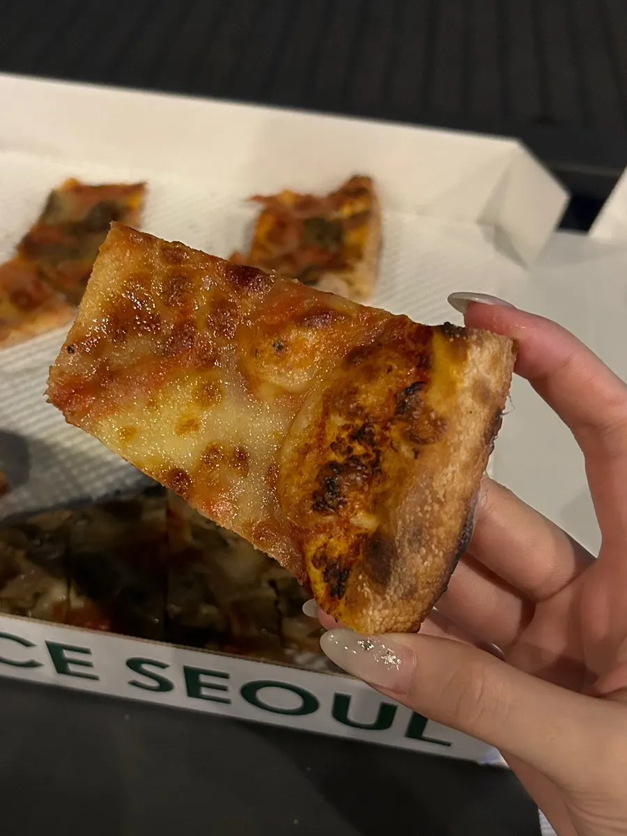 Cross-section of the cheese slice showing the thin crust