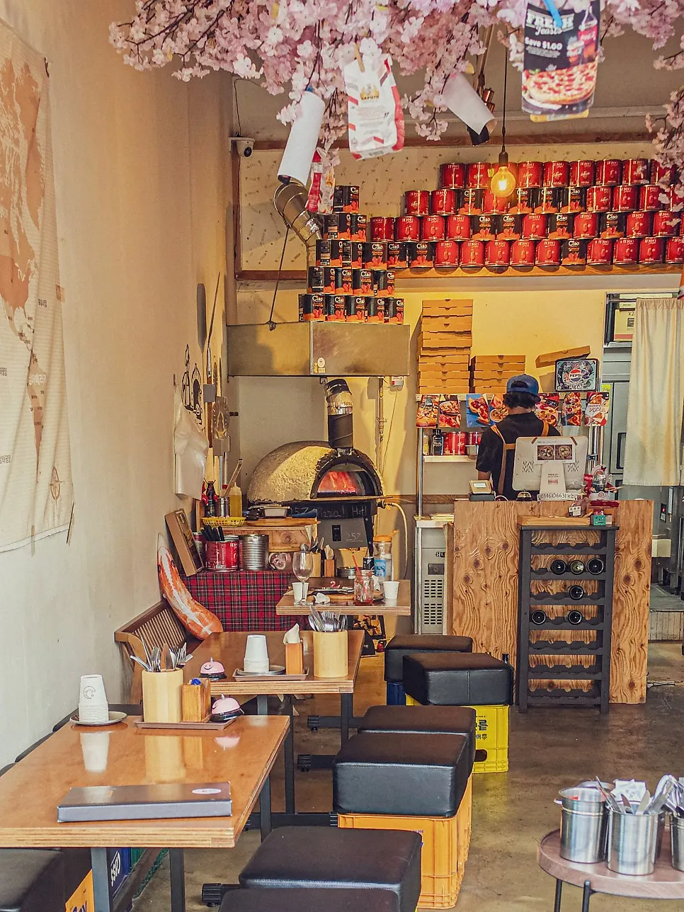 Table seating with a view of the wood oven and kitchen