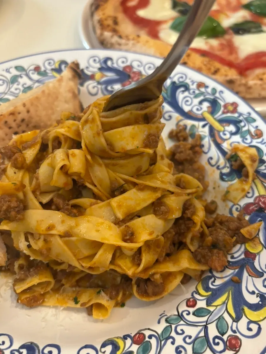 Close-up of pasta topped with ragu sauce