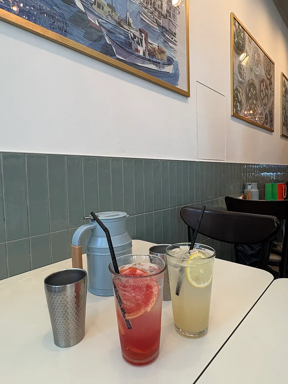 Refreshing ade next to pizza on the table