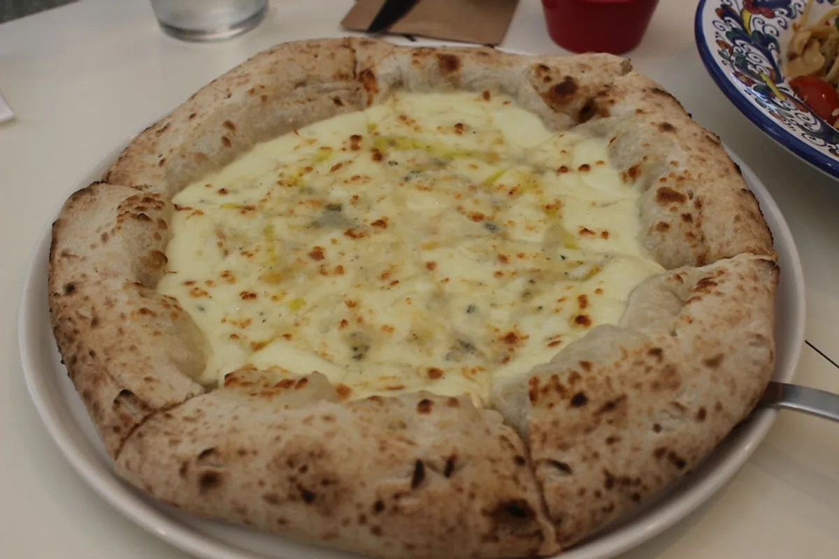 Gorgonzola pizza fresh out of the wood-fired oven