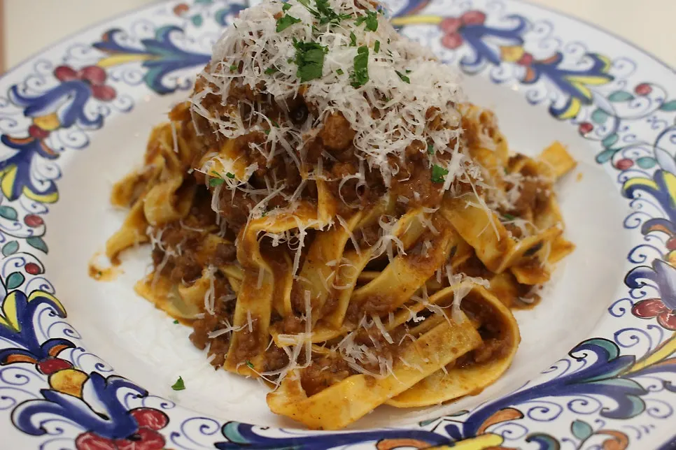 A plate of ragu pasta with flat fresh noodles
