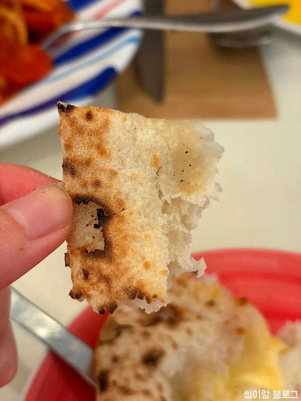 A slice of Quattro Formaggi pizza with honey drizzle