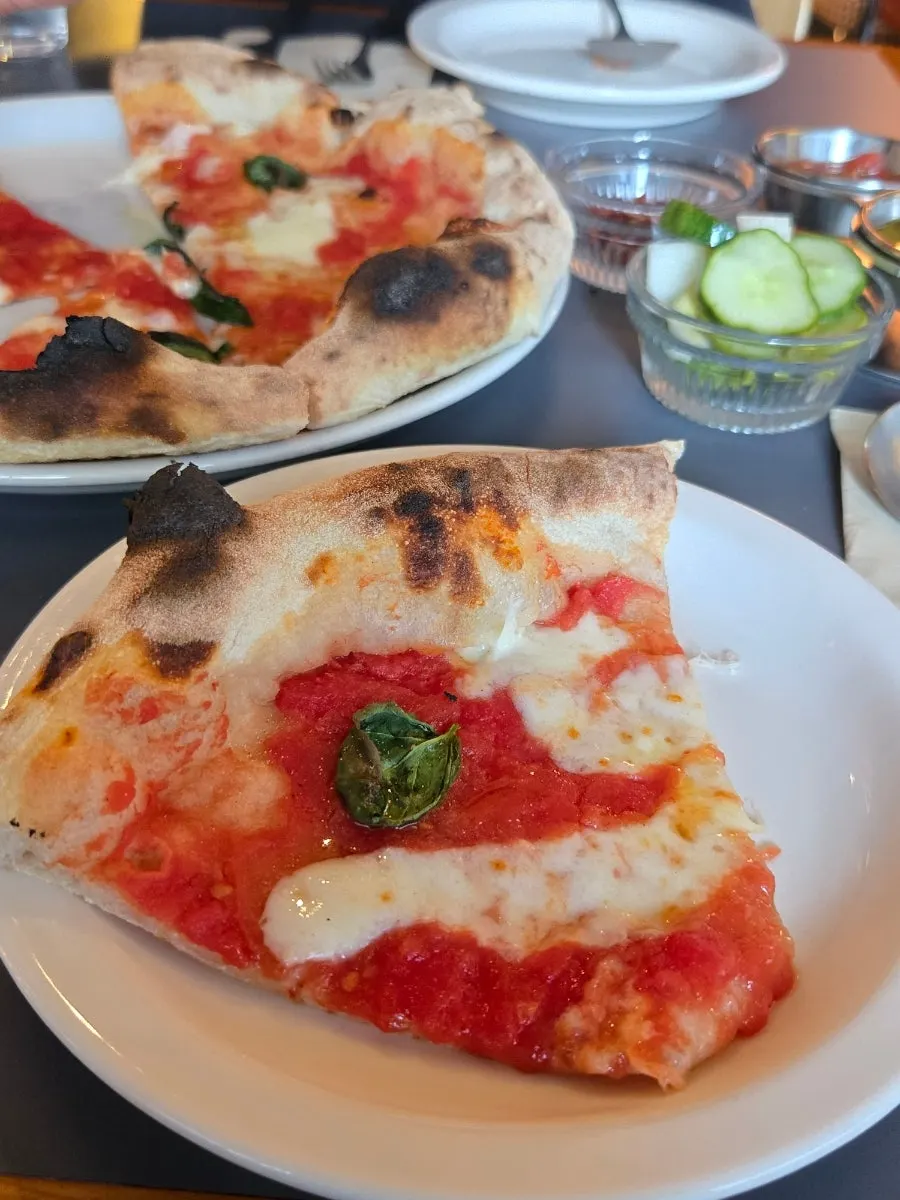 Margherita pizza showing slightly charred crust edges