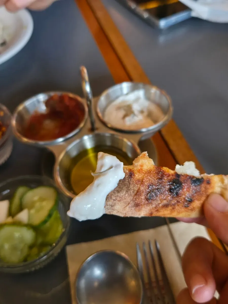Pizza slice topped with olive oil and pepperoncino