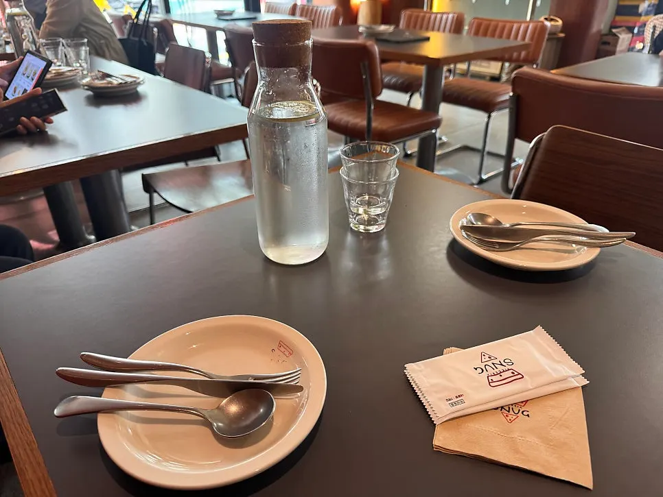 Dining hall arranged mostly with 4-person tables